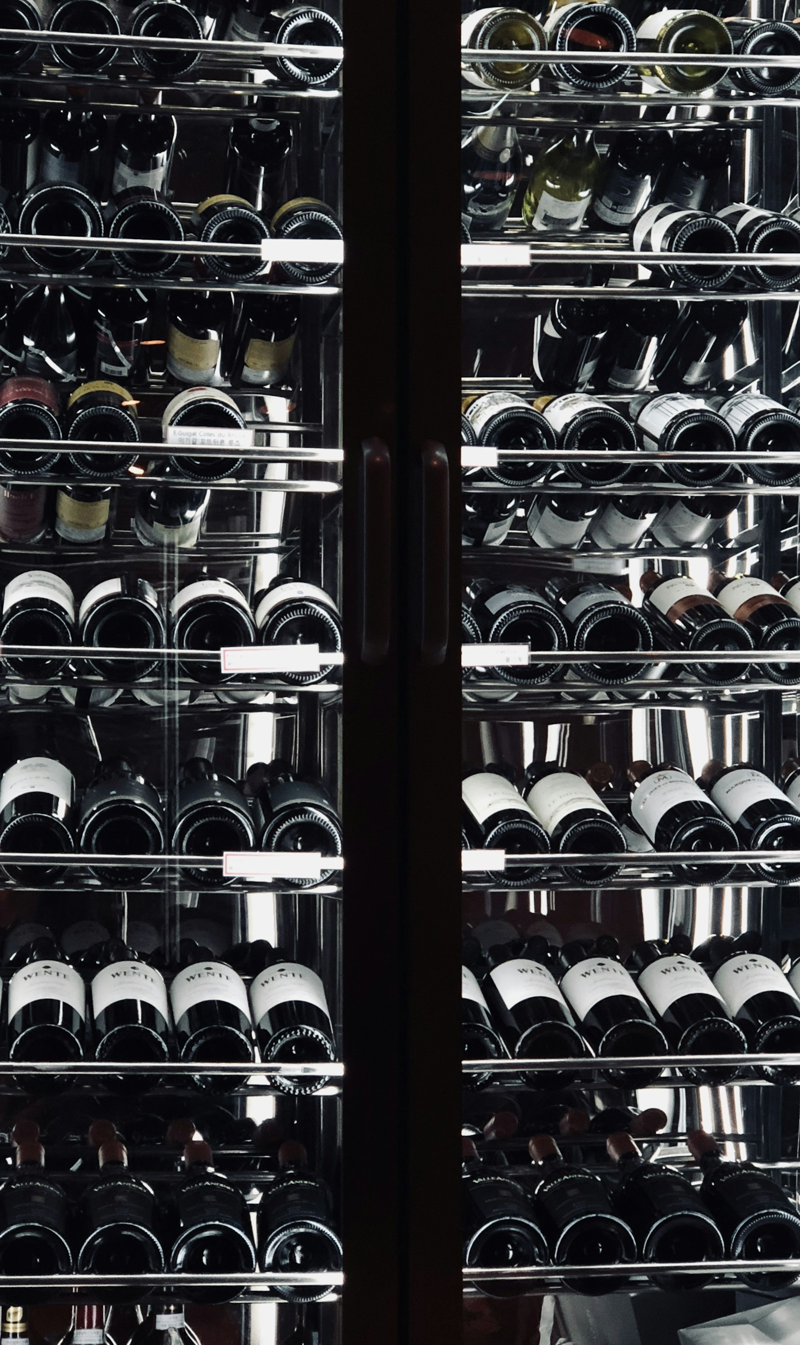 Monogram glass-door beverage center with bottles and cans — expert Monogram beverage center repair