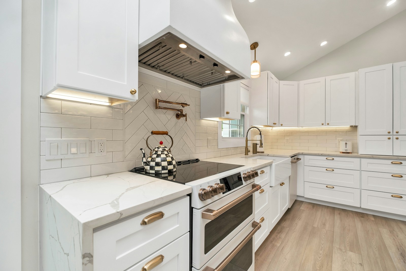 Monogram range hood over a cooktop in a modern kitchen — certified Monogram range hood service