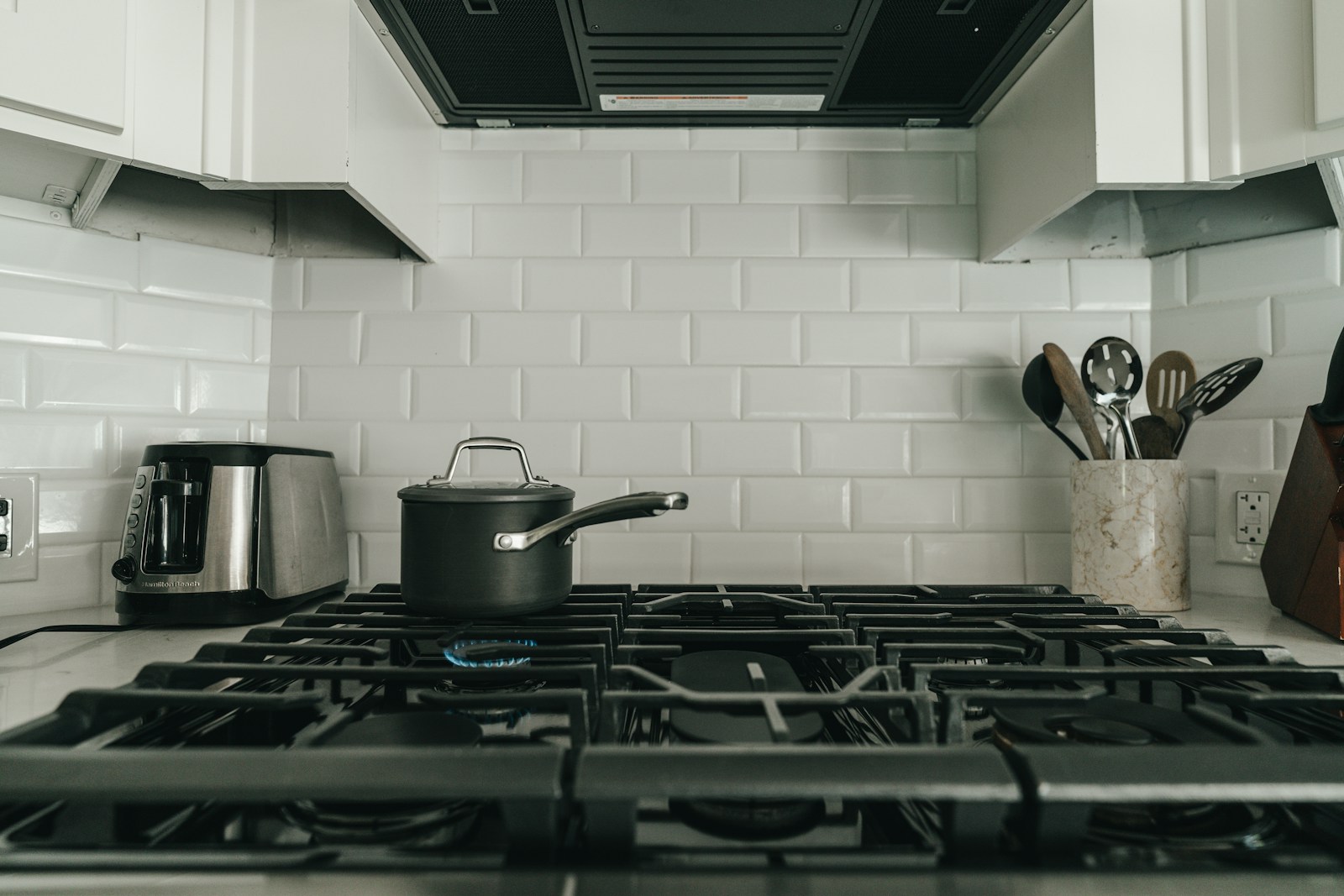 Monogram rangetop with continuous grates in a pro kitchen — expert Monogram rangetop repair