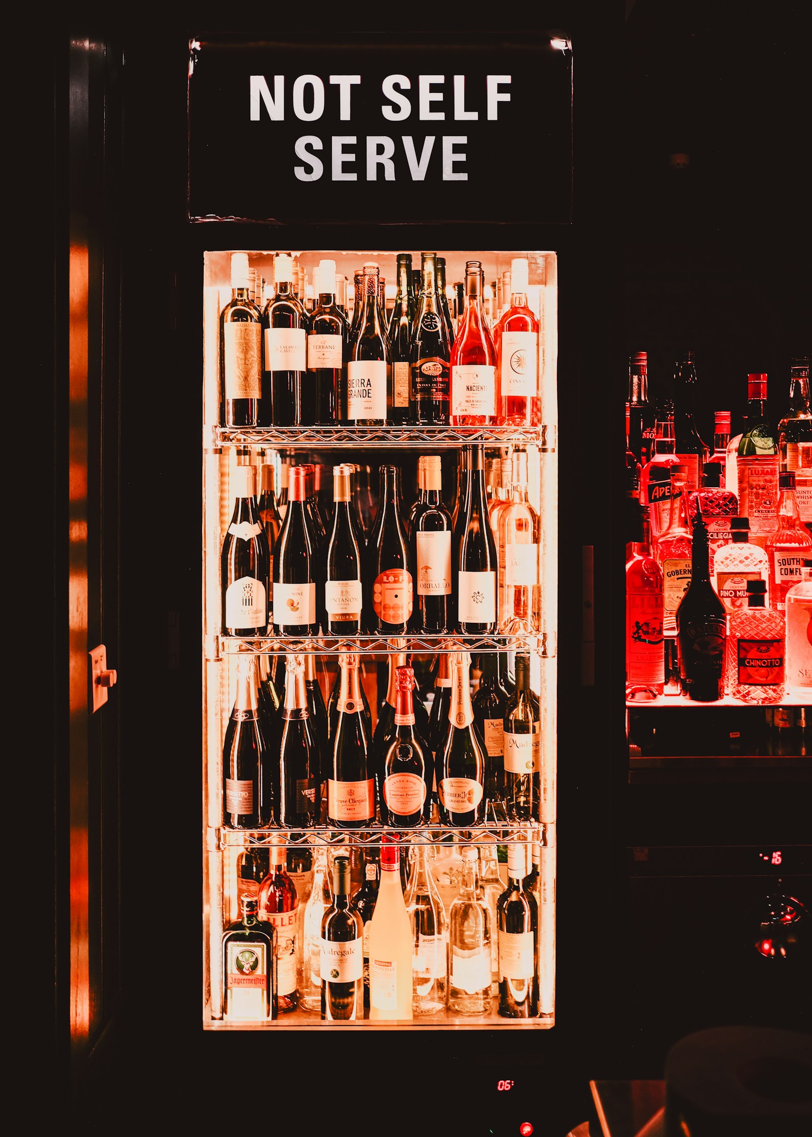 Monogram wine refrigeration cabinet with chilled bottles behind glass — Monogram wine refrigeration diagnostics